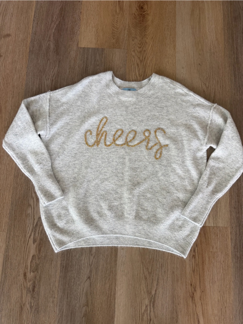 CeCe Cream Knit Sweater with Gold 'cheers' Script